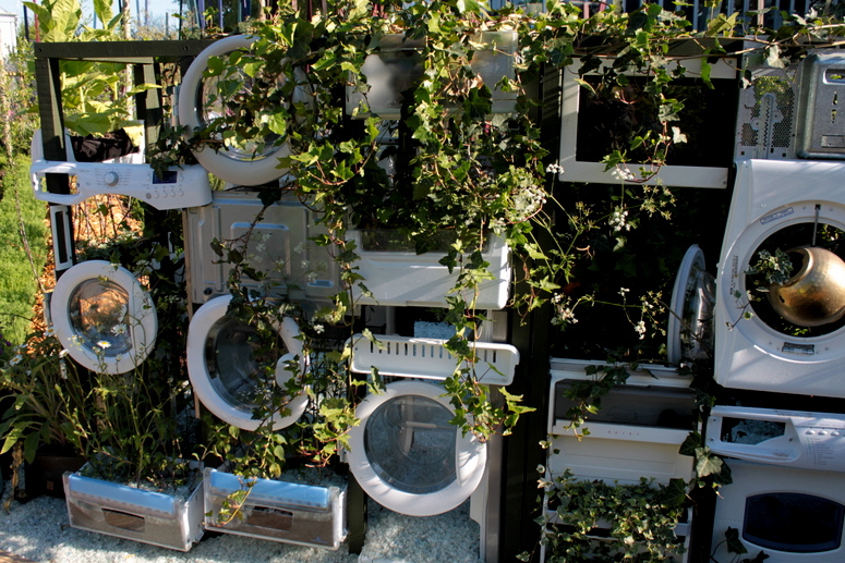 Garden wall made of old washing machines etc Garden wall made of old washing machines etc